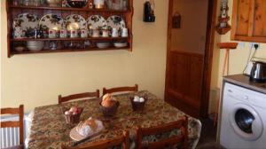 uma mesa numa cozinha com uma mesa de sidx sidx sidx em The Cosy Barn em Kilrush