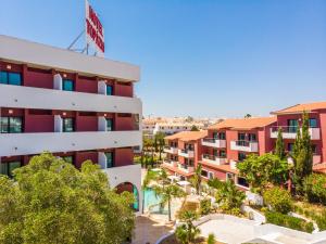 a view of a building with trees in front of it at Topazio Vibe Beach Hotel & Apartments - Adults Friendly in Albufeira