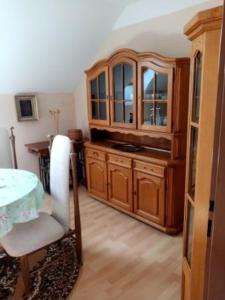 a kitchen with a wooden cabinet and a table at Apartmán Podskalská Blatná in Blatná