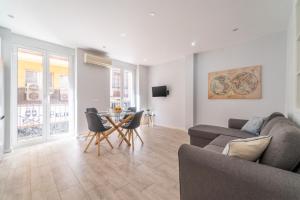 a living room with a couch and a table and chairs at MyFlats SF 54 in Alicante