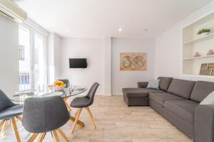 a living room with a couch and chairs and a table at MyFlats SF 54 in Alicante