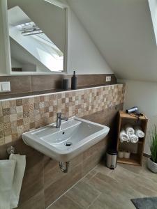 a bathroom with a sink and a mirror at Sonnenufer Apartment & Moselwein I in Bernkastel-Kues