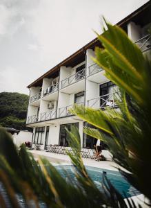 a white building with a pool in front of it at Vila La Faleza Dubova in Dubova