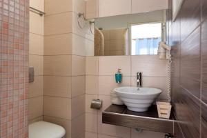 a bathroom with a sink and a toilet at Seaside Breeze in Kamari
