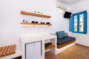 a living room with a table and a bench and a window at Seaside Breeze in Kamari