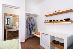 a bathroom with a sink and a mirror at Seaside Breeze in Kamari