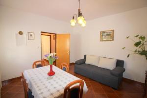 a living room with a table and a couch at Apartment Liliana near beach in Poreč