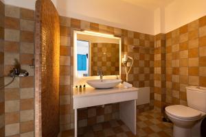 a bathroom with a sink and a toilet and a mirror at Seaside Breeze in Kamari