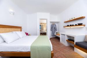 a bedroom with a bed and a desk in a room at Seaside Breeze in Kamari