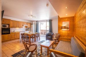 a kitchen and living room with a table and chairs at Cellier n3 in Les Deux Alpes