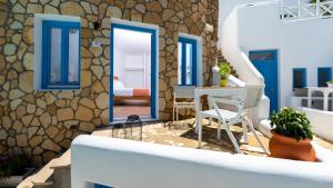 a living room with blue doors and a table and chairs at Seaside Breeze in Kamari