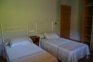 a room with two beds and a closet at Ruiloba II in Ribadesella