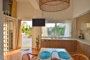 a kitchen with a table and chairs and a window at Mpoulakis Apt 46 in Kissamos