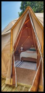 a canvas tent with a bed in it at Sottu E Stelle in Albitreccia
