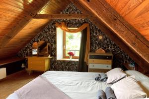 a bedroom with a bed and a window at Petite maison de campagne in Plouëc-du-Trieux