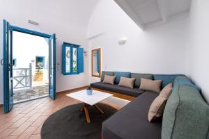 a living room with a couch and a table at Seaside Breeze in Kamari