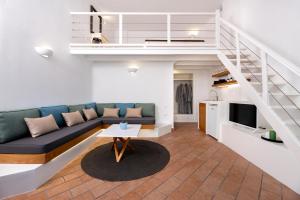 a living room with a couch and a tv at Seaside Breeze in Kamari