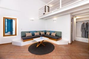 a living room with a couch and a table at Seaside Breeze in Kamari
