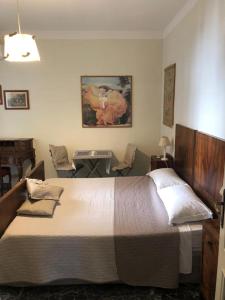 a bedroom with a large bed and a desk with chairs at All My Home in Villa San Giovanni