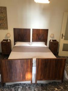 a bedroom with a large bed with wooden furniture at All My Home in Villa San Giovanni +18 photos