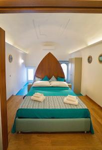 a bedroom with a large bed with two towels on it at Grotta Verde Luxury Suite by CapriRooms in Capri