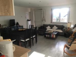 a living room with a couch and a table at Gîte chez Laurence in Les Fins