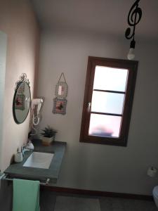a bathroom with a sink and a window at La Casa Nell'Aia in Monsummano