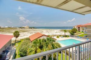 a view from the balcony of a condo with a pool and the beach at Navarre Beach Sunset Condo in Navarre