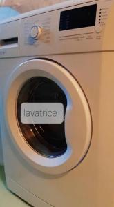 a white washing machine with the word laundry written on it at Delma's home in San Daniele del Friuli