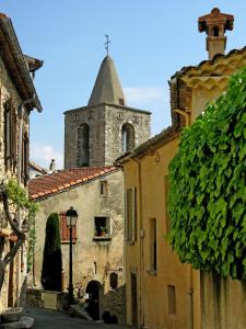 an old building with a tower and a street at Gîte de Saint Cassien in Montauroux