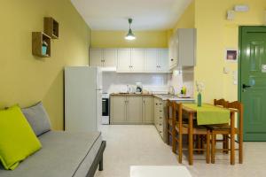 a kitchen with a couch and a table in a room at Elaionas in Leonidio