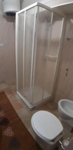 a bathroom with a toilet and a shower at GAIA Accommodation in Alghero