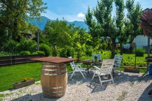 a wooden table and chairs and a table and chairs at Apartmaji Prton Bovec in Bovec