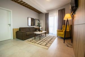 a living room with a couch and a table at Hotel Hills Ulcinj in Ulcinj