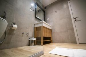 a bathroom with a shower with a sink and a mirror at Hotel Hills Ulcinj in Ulcinj +29 photos