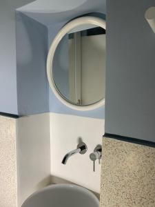 a bathroom with a sink and a mirror at IANUA Casa per Viaggiatori in Astypalaia