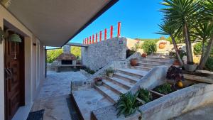 a set of stairs leading up to a house at Apartments Tanja in Zavalatica