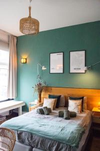 a bedroom with a large bed with a green wall at PERFECT B&B MIDDLE OF AMSTERDAM in Amsterdam