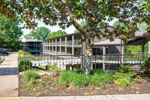 a building with a tree in front of it at Barren River Lake State Resort Park in Lucas