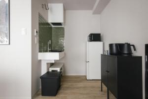 a kitchen with a white refrigerator and a wooden floor at THREE - Vacation STAY 38687v in Tokyo