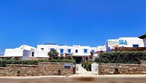 a row of white buildings in front of a street at ThalaSEA - village Antiparos in Antiparos