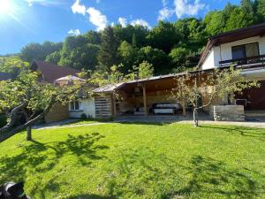 a house with a grass yard in front of it at Bystra 14 in Brezno