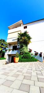 a building with palm trees in front of it at Apartments Sime in Sukošan