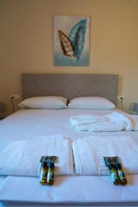 a white bed with towels on it at Charikleia's 2 bedroom appartment in Pelion in Volos