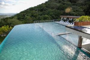 a pool of water with a mountain in the background at Resort Ecoar in Gaspar