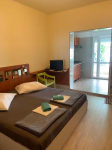 a bedroom with a large bed with two towels on it at Seafront aparment in Podgora
