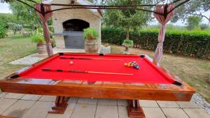 a red pool table with cue balls on it at Apartments Sime in Sukošan