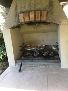 a brick oven with chickens cooking in it at Lime trees in Arnac-Pompadour