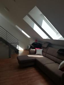 a living room with a couch and a large skylight at Stadthaus Kaufbeuren in Kaufbeuren