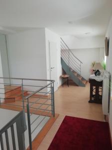 a room with a staircase and a red rug at Stadthaus Kaufbeuren in Kaufbeuren